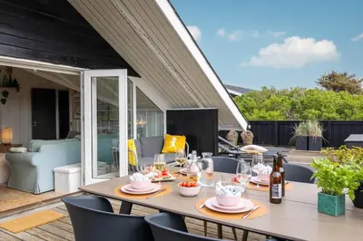 a table and chairs on the patio of a house at 804-Harboore-Neerlandiavej-214 in Harboør
