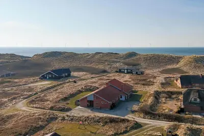 an aerial view of a farm with the ocean in the background at 803-Harboore-Merchantvej-9-A in Harboør