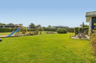 a large yard with a slide and a playground at G410-Lemvig-Porsevej-10 in Lemvig