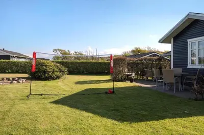 a yard with two red flags in the grass at G410-Lemvig-Porsevej-10 in Lemvig