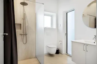 a bathroom with a shower and a toilet and a sink at G422-Lemvig-Pragtstjernevej-22 in Lemvig