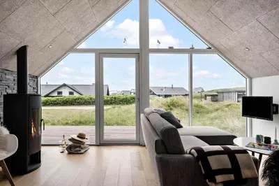 a living room with a couch and a large window at 805-Harboore-Vejlby-klit-247 in Harboør