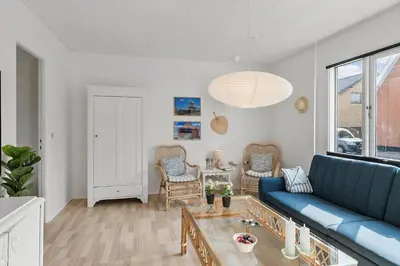 a living room with a blue couch and a table at 727-Thyboron-Magevej-10 in Thyborøn
