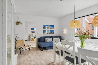 a living room with a table and a blue couch at 727-Thyboron-Magevej-10 in Thyborøn
