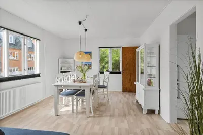 a white dining room with a white table and chairs at 727-Thyboron-Magevej-10 in Thyborøn
