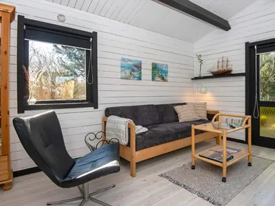 a living room with a couch and a chair at 4 person holiday home in Nibe-By Traum in Nibe