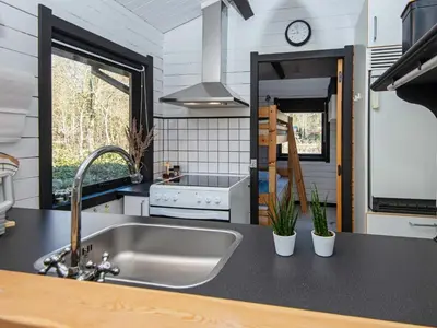 a kitchen with a sink and a stove at 4 person holiday home in Nibe-By Traum in Nibe