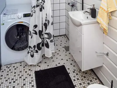 a bathroom with a washing machine and a sink at 4 person holiday home in Nibe-By Traum in Nibe