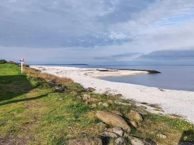 a beach with a sign on the side of it at 5 person holiday home in Løgstør in Løgstør