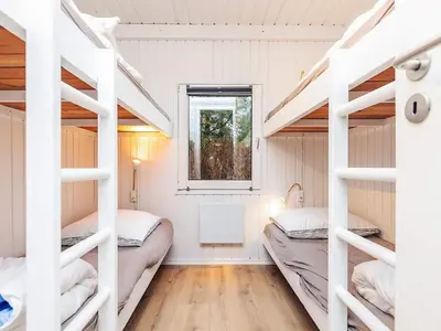 a room with two bunk beds and a window at 12 person holiday home in Saltum-By Traum in Saltum