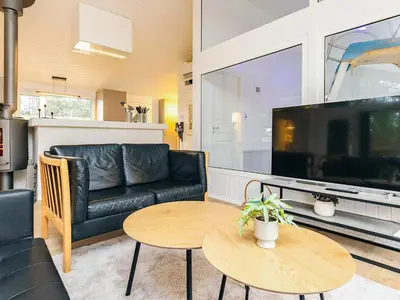 a living room with a couch and a table at 12 person holiday home in Saltum-By Traum in Saltum