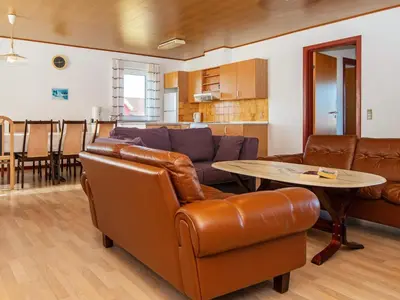 a living room with a couch and a table at 10 person holiday home in Harboøre-By Traum in Harboør