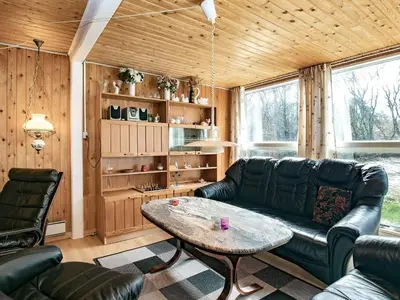 a living room with a couch and a table at 6 person holiday home in Hurup Thy-By Traum in Sindrup