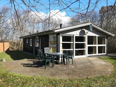 a patio with a table and chairs in front of a building at 6 person holiday home in Hurup Thy-By Traum in Sindrup