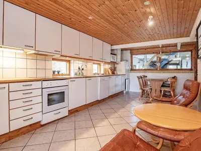 a kitchen with a table and a wooden ceiling at 10 person holiday home in Fur in Fur