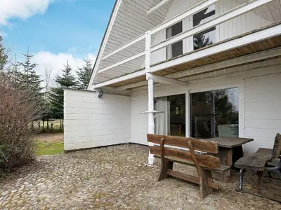 a wooden bench sitting outside of a house at 10 person holiday home in Fur in Fur