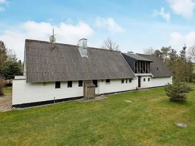 a white barn with a roof on a field at 10 person holiday home in Fur in Fur