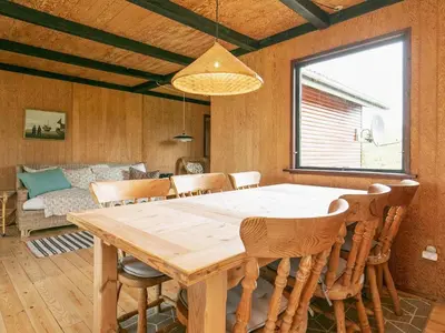 a dining room with a wooden table and chairs at 6 person holiday home in Vinderup in Vinderup