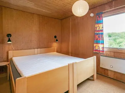 a bedroom with a bed in a room with a window at 6 person holiday home in Vinderup in Vinderup