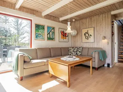 a living room with a couch and a table at 6 person holiday home in Thyholm in Thyholm