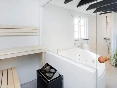 a white bathroom with a tub and a window at 7 person holiday home in Fjerritslev-By Traum in Fjerritslev