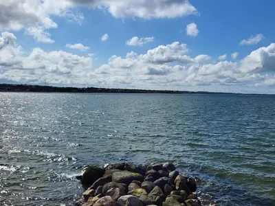 a large body of water with rocks in the water at 8 person holiday home in Vinderup-By Traum in Vinderup