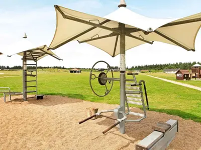 a playground with a white umbrella and a swing at 6 person holiday home in Brovst-By Traum in Brovst