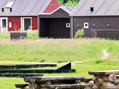 a barn and a red barn with a building at 6 person holiday home in Brovst-By Traum in Brovst