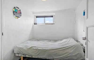 a small bed in a white room with a window at Stunning Home In Harboøre With Wifi in Harboør