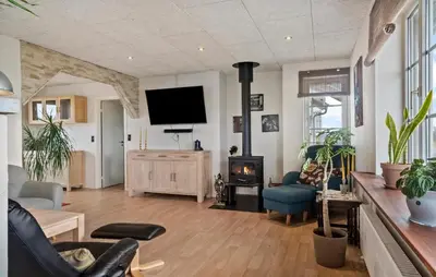 a living room with a fireplace and a tv at Stunning Home In Harboøre With Wifi in Harboør