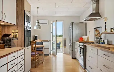 a kitchen with a stainless steel refrigerator and a table at Stunning Home In Harboøre With Wifi in Harboør