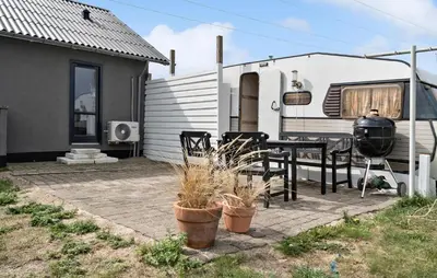 a patio with a grill and a table and chairs at Stunning Home In Harboøre With Wifi in Harboør