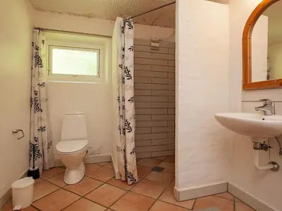 a bathroom with a toilet and a sink at Luxury Retreat with Pool - By Traum Ferienwohnungen in Thyholm