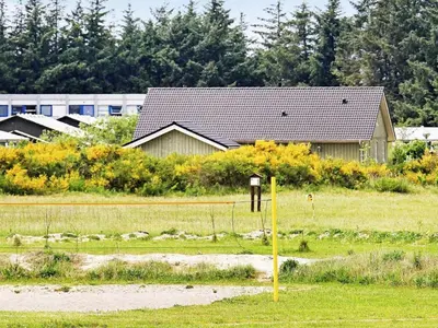 a house in the middle of a field at Holiday home for 24 guests, Brovst in Brovst