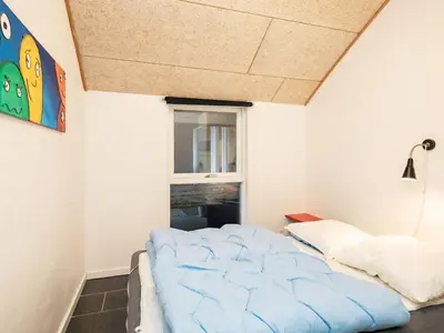 a bedroom with a bed and a window at Holiday home for 24 guests, Brovst in Brovst