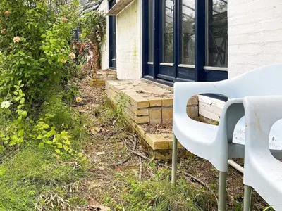 a white chair sitting in front of a house at Scenic Retreat in Boddum - By Traum Ferienwohnungen in Boddum