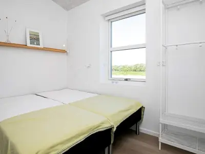 a white room with two beds and a window at 22 person holiday home in Løkken-By Traum in Løkken