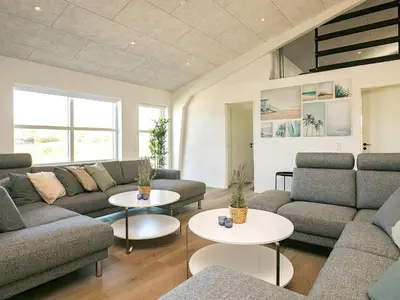 a living room with couches and tables at 22 person holiday home in Løkken-By Traum in Løkken