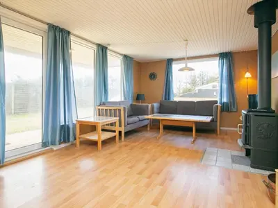 a living room with a couch and a table at 6 person holiday home in Løkken in Løkken