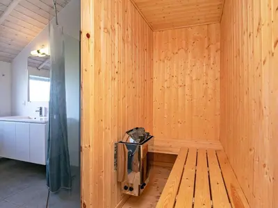 a wooden room with a tub and a sink at 10 person holiday home in Harboøre in Harboør