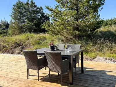 a table and chairs on a wooden deck at Luxury Retreat in Klitmoller - By Traum Ferienwohnungen in Thisted