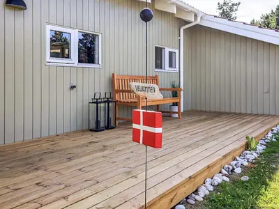 a wooden deck with a bench on a house at Luxury Retreat in Klitmoller - By Traum Ferienwohnungen in Thisted