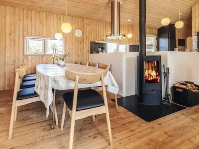 a dining room with a table and a fireplace at Luxury Retreat in Klitmoller - By Traum Ferienwohnungen in Thisted