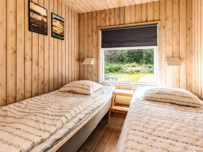 two beds in a room with a window at Luxury Retreat in Klitmoller - By Traum Ferienwohnungen in Thisted