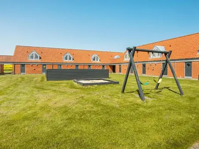 a park with a swing set and a bench at 6 person holiday home in Lemvig-By Traum in Lemvig