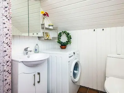 a white bathroom with a washing machine and a sink at 6 person holiday home in Harboøre-By Traum in Harboør