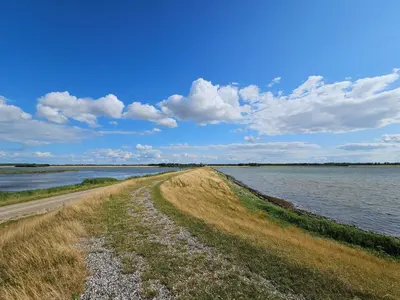 a dirt road next to a body of water at 6 person holiday home in Harboøre-By Traum in Harboør