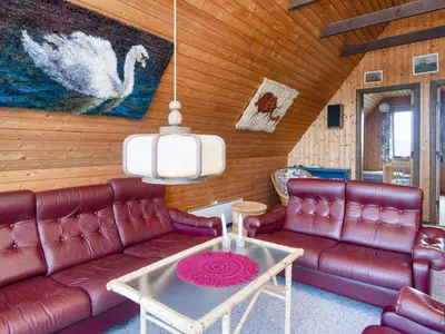 a living room with red leather couches and a table at 5 person holiday home in Harboøre-By Traum in Harboør