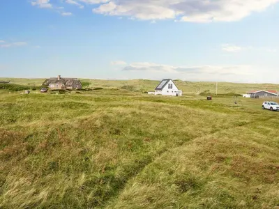 a field of grass with houses and a car on it at 5 person holiday home in Harboøre-By Traum in Harboør