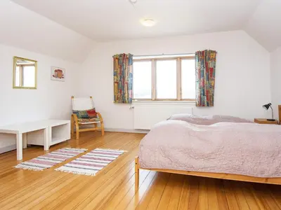 a bedroom with a bed and a desk and a window at 8 person holiday home in Thyborøn-By Traum in Thyborøn